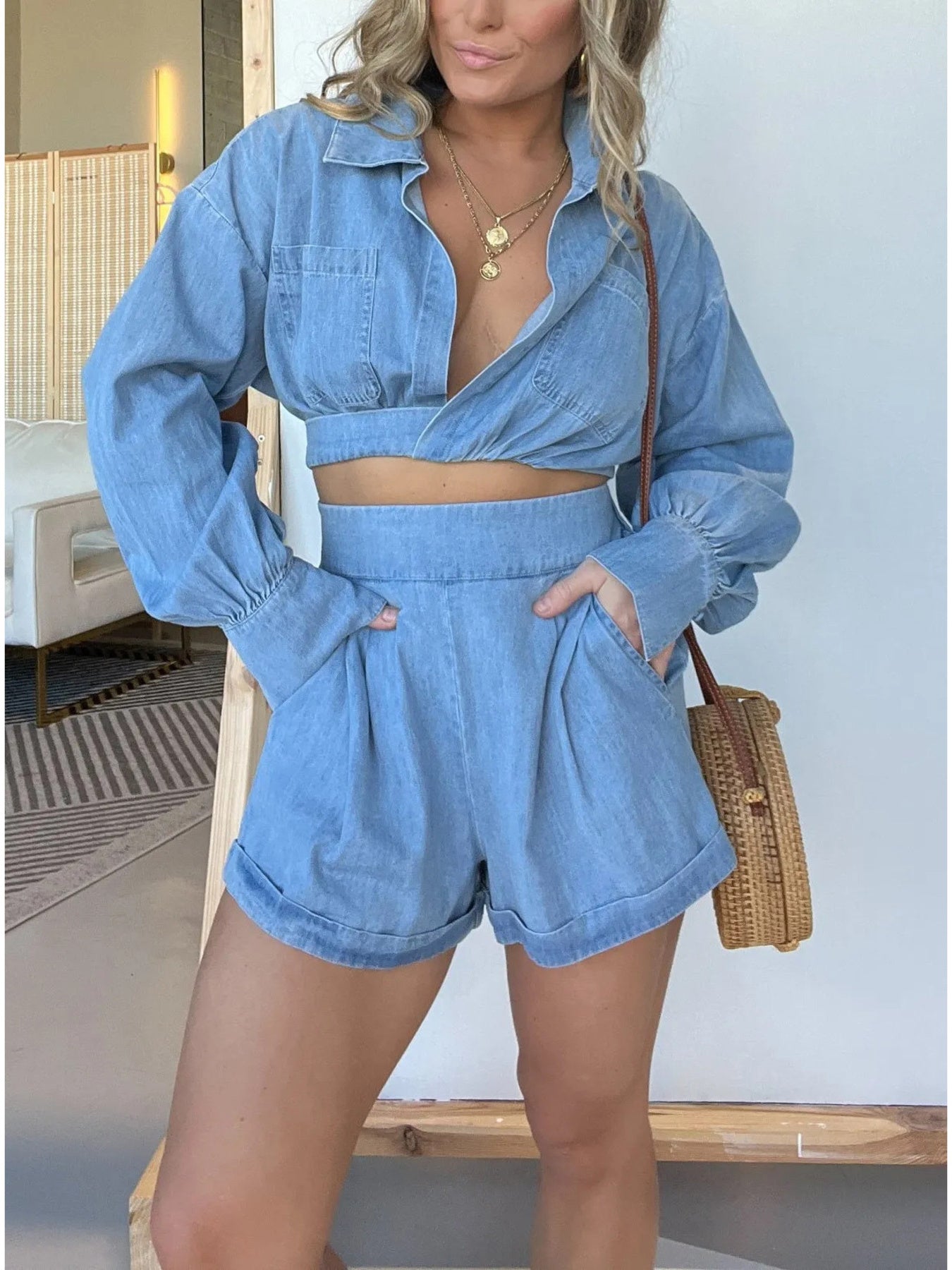 Blue long sleeve denim crop top and matching shorts two-piece set, worn with top tied at front