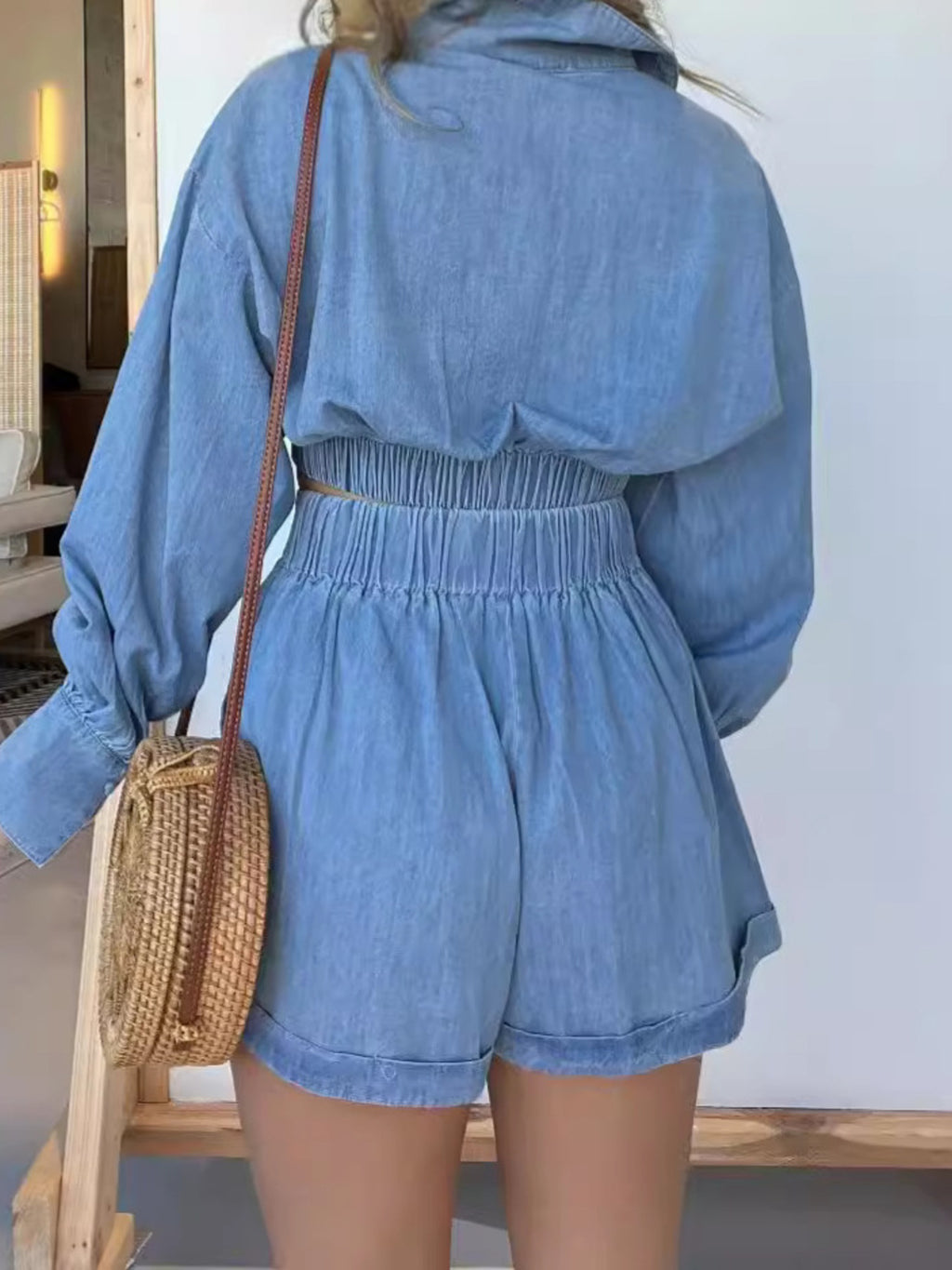 Blue long sleeve denim crop top and matching shorts two-piece set, worn with top tied at front
