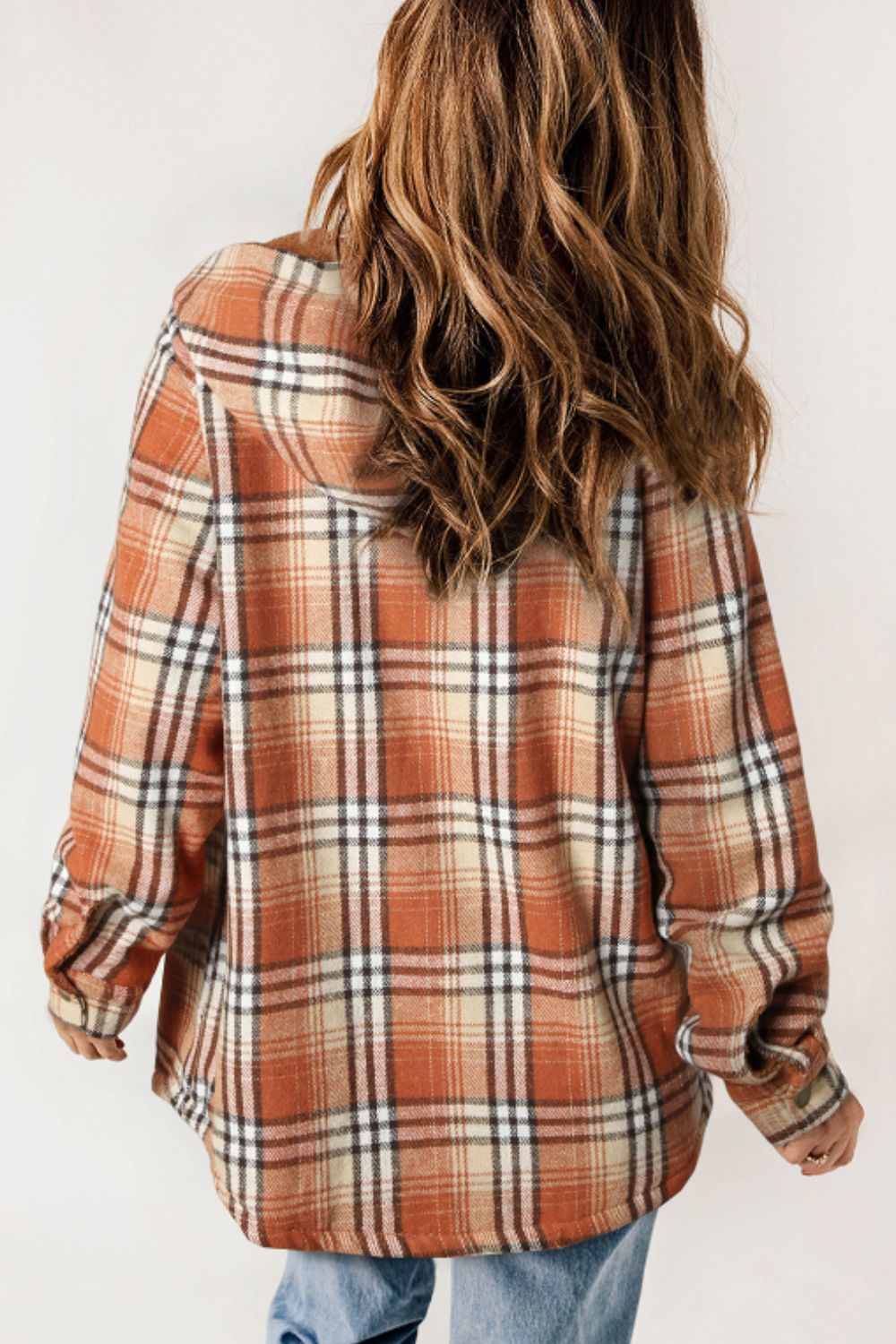 Multicolor plaid button-up shacket with sherpa-lined hood, worn open over a cream sweater