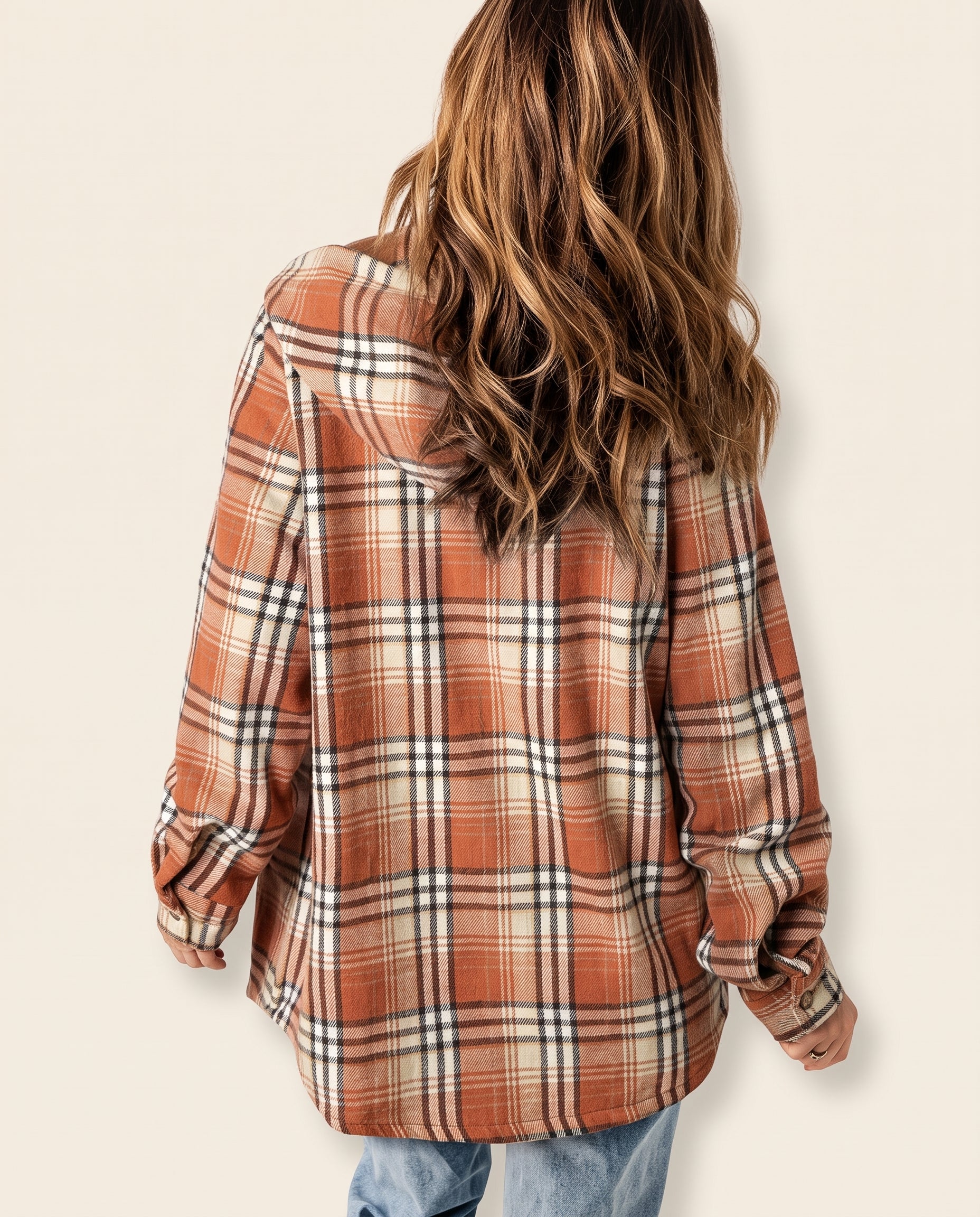 Multicolor plaid button-up shacket with sherpa-lined hood, worn open over a cream sweater