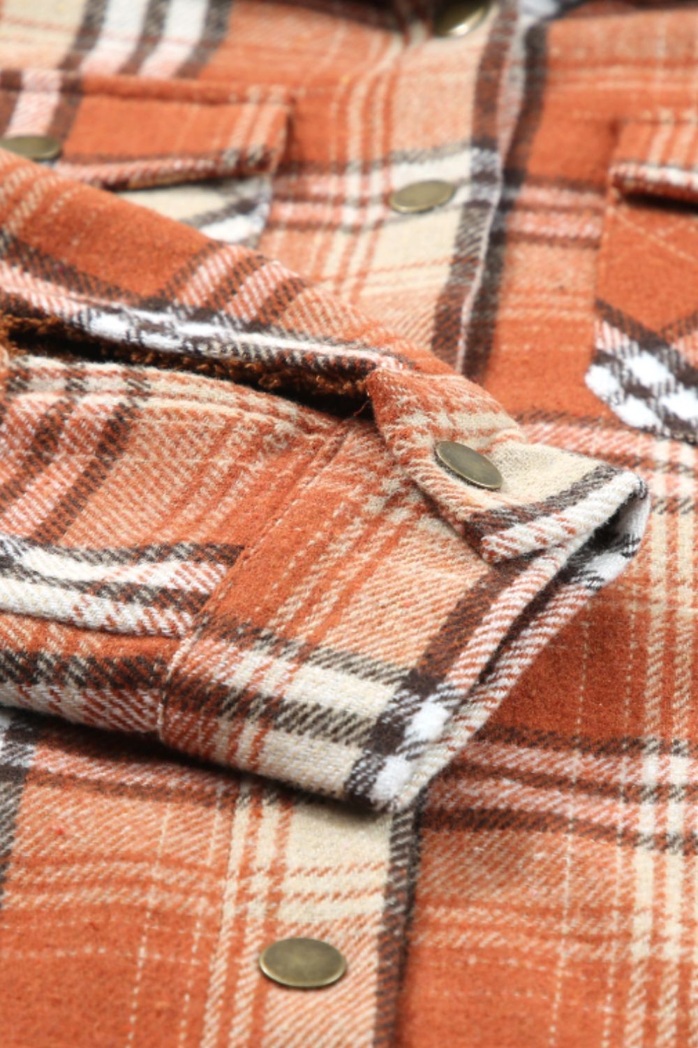 Multicolor plaid button-up shacket with sherpa-lined hood, worn open over a cream sweater