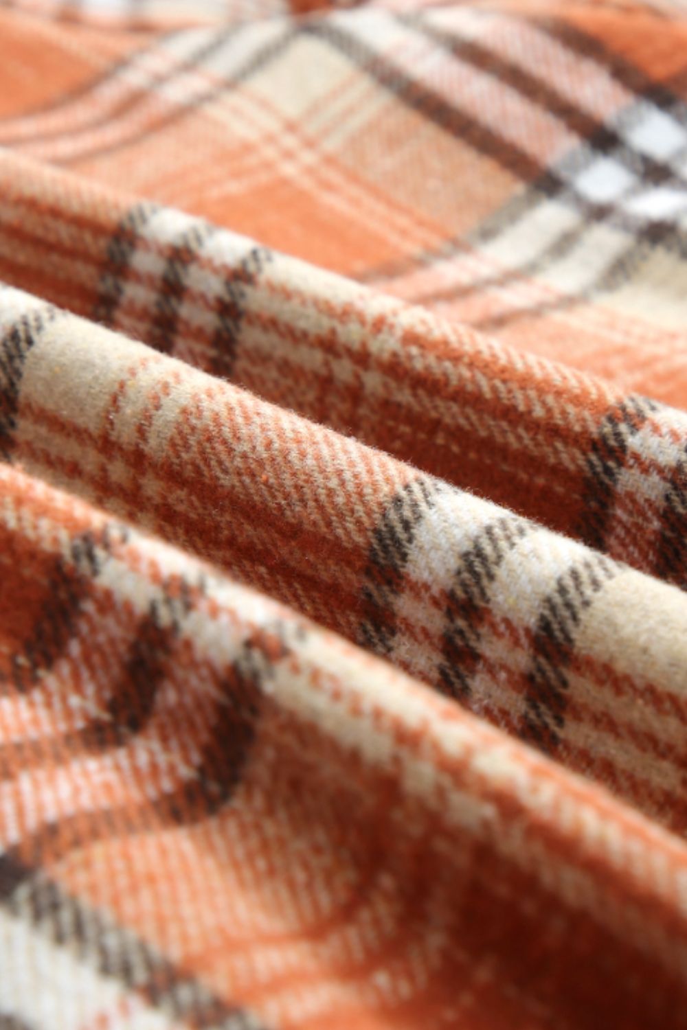 Multicolor plaid button-up shacket with sherpa-lined hood, worn open over a cream sweater