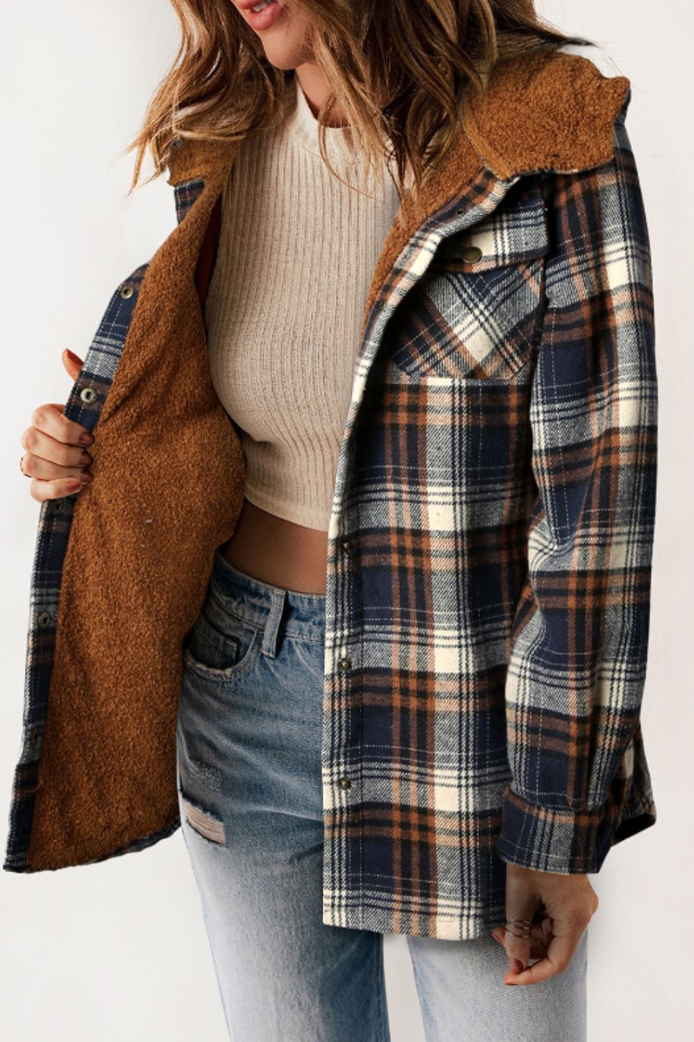 Multicolor plaid button-up shacket with sherpa-lined hood, worn open over a cream sweater