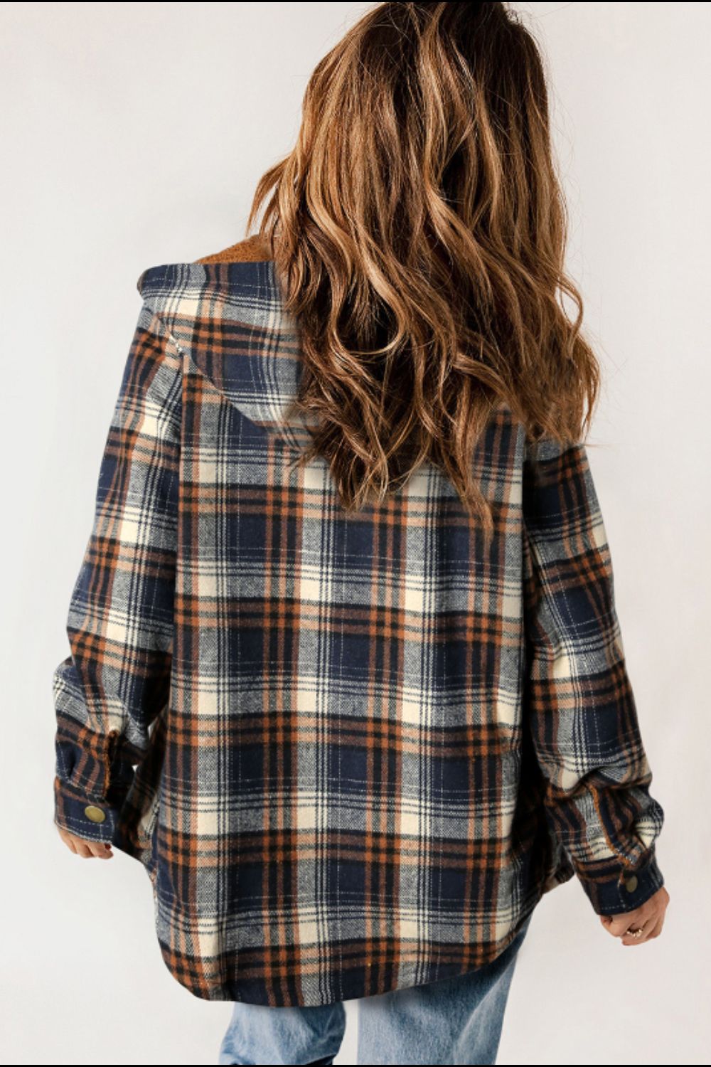 Multicolor plaid button-up shacket with sherpa-lined hood, worn open over a cream sweater