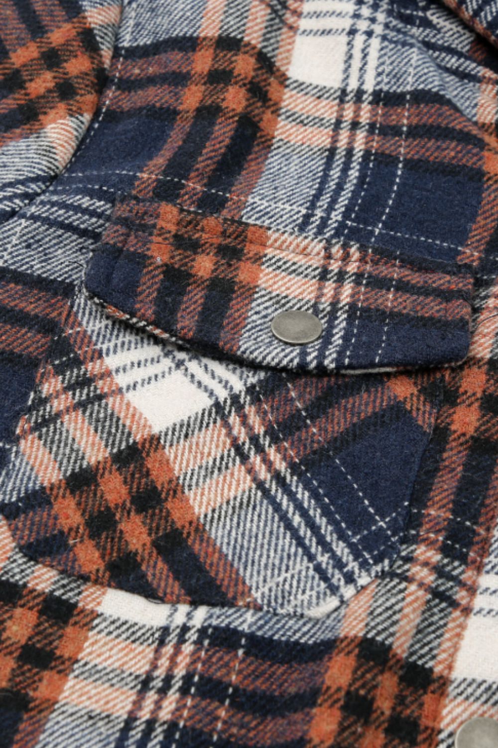 Multicolor plaid button-up shacket with sherpa-lined hood, worn open over a cream sweater