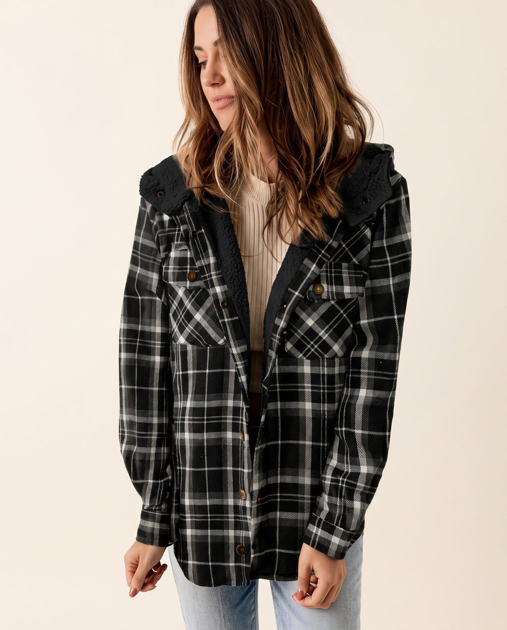 Multicolor plaid button-up shacket with sherpa-lined hood, worn open over a cream sweater