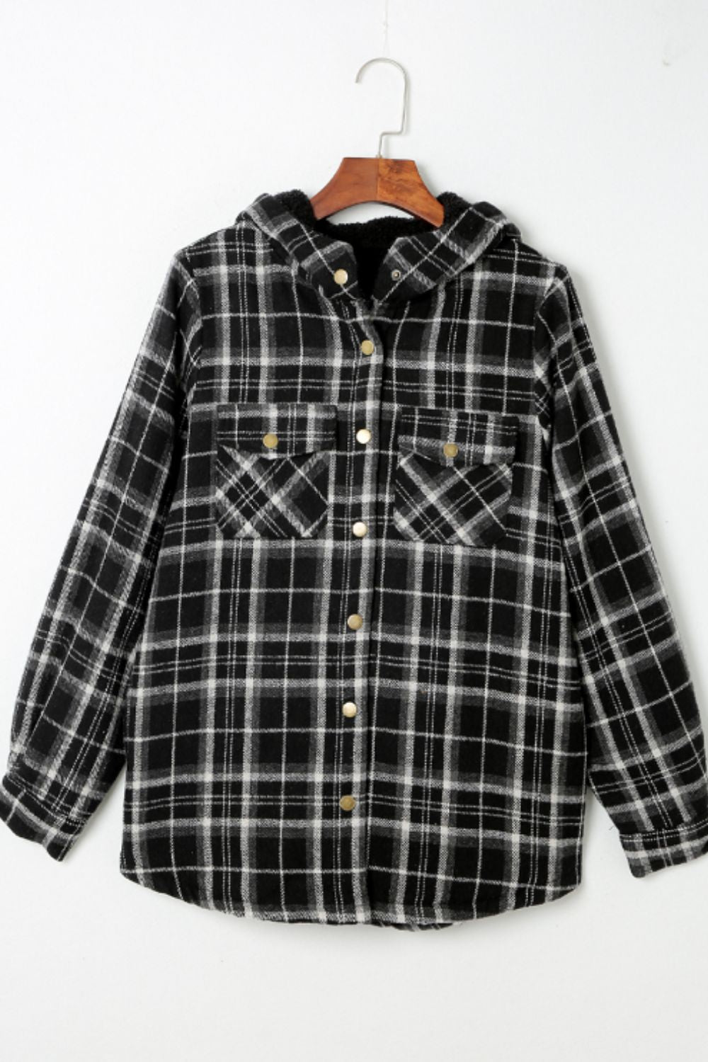 Multicolor plaid button-up shacket with sherpa-lined hood, worn open over a cream sweater