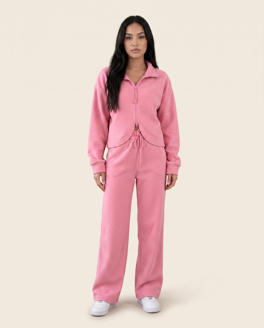 Dusty pink zip-up hoodie and drawstring wide-leg loungewear set, worn with hand raised to hair