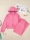 Dusty pink zip-up hoodie and drawstring wide-leg loungewear set, worn with hand raised to hair