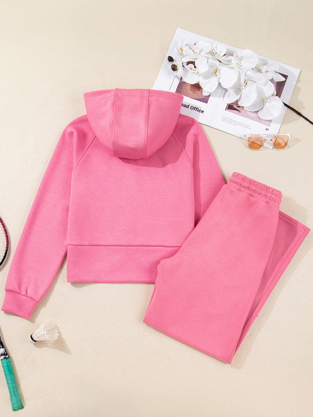 Dusty pink zip-up hoodie and drawstring wide-leg loungewear set, worn with hand raised to hair