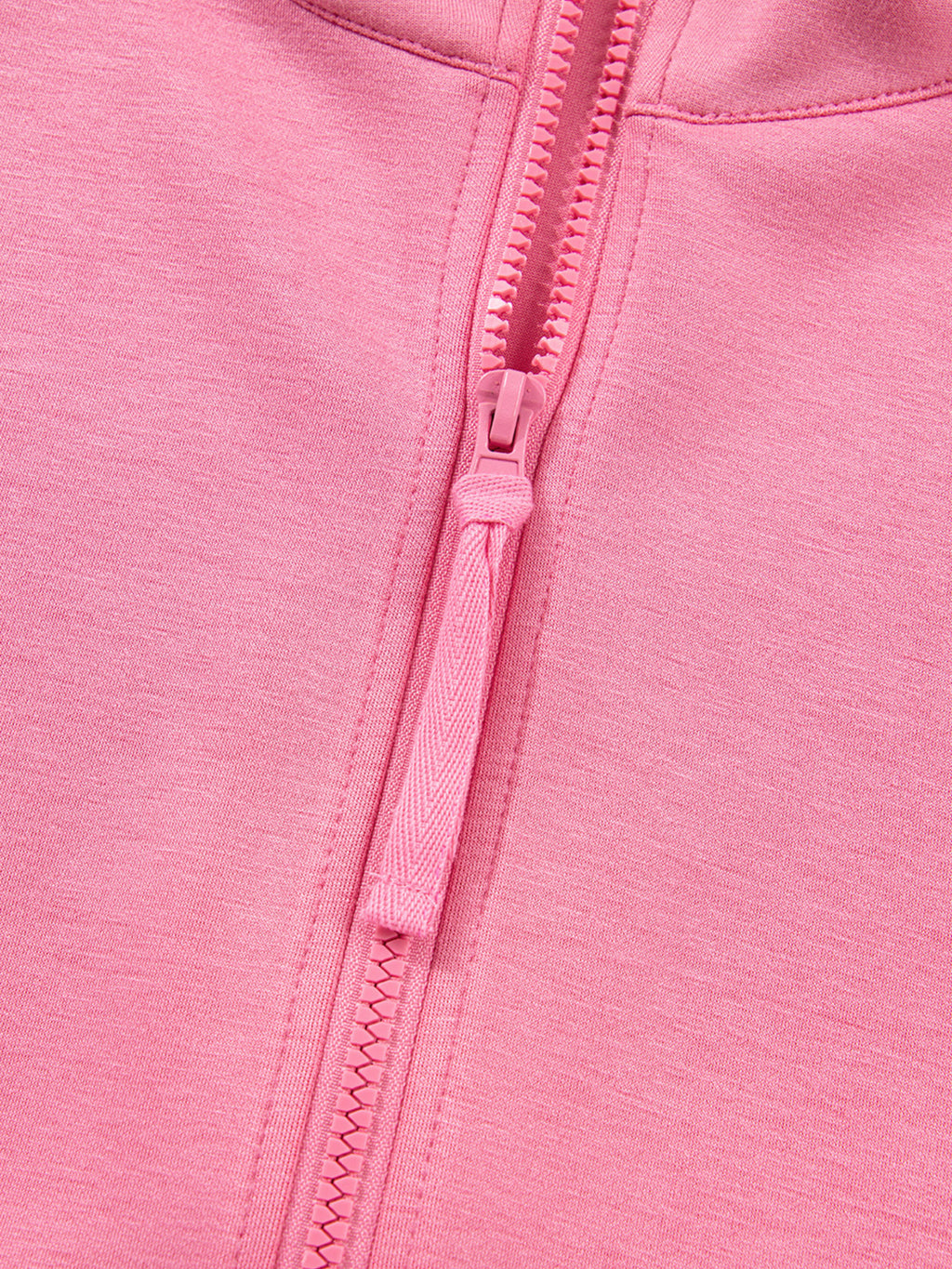 Dusty pink zip-up hoodie and drawstring wide-leg loungewear set, worn with hand raised to hair