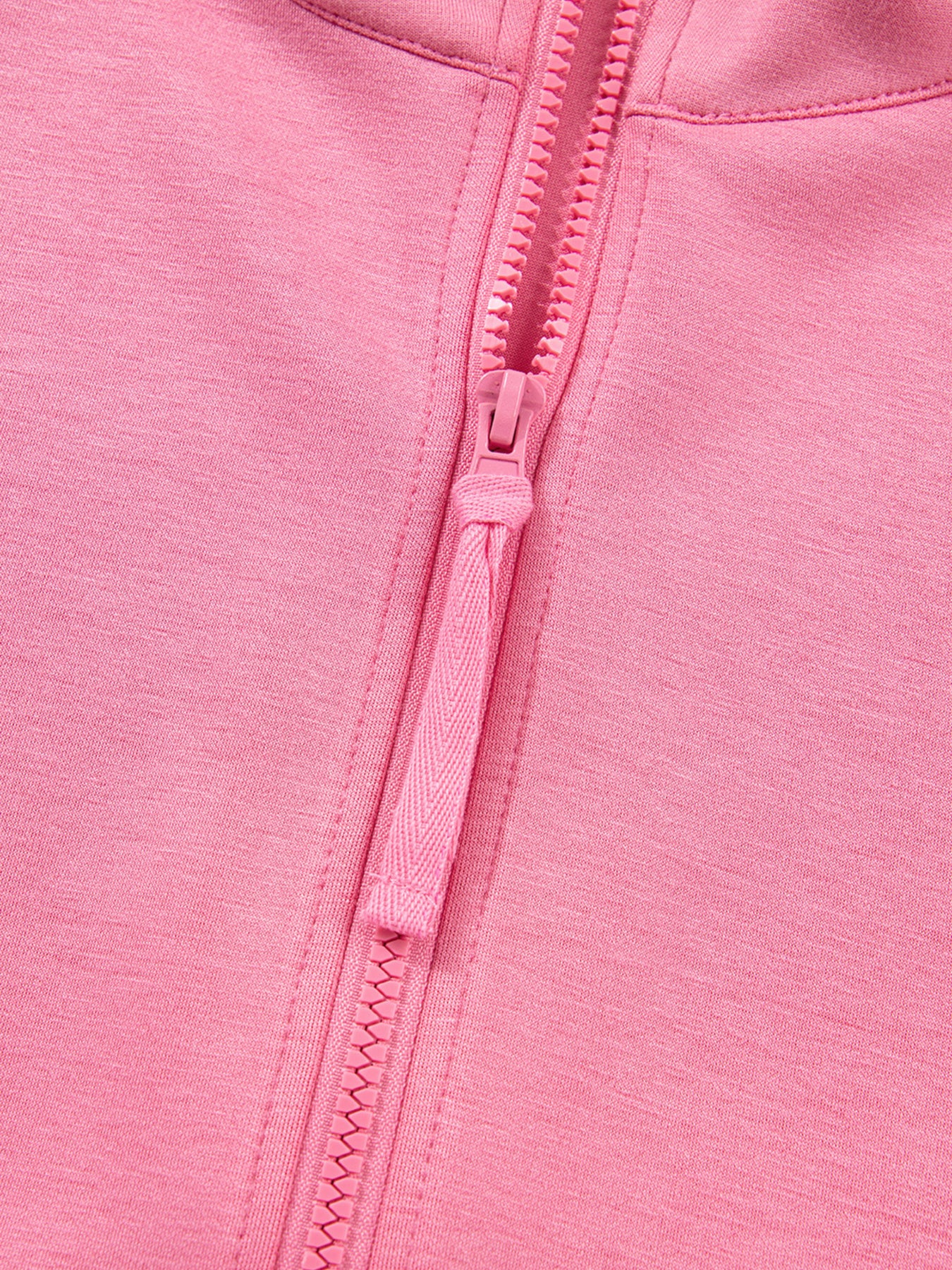 Dusty pink zip-up hoodie and drawstring wide-leg loungewear set, worn with hand raised to hair