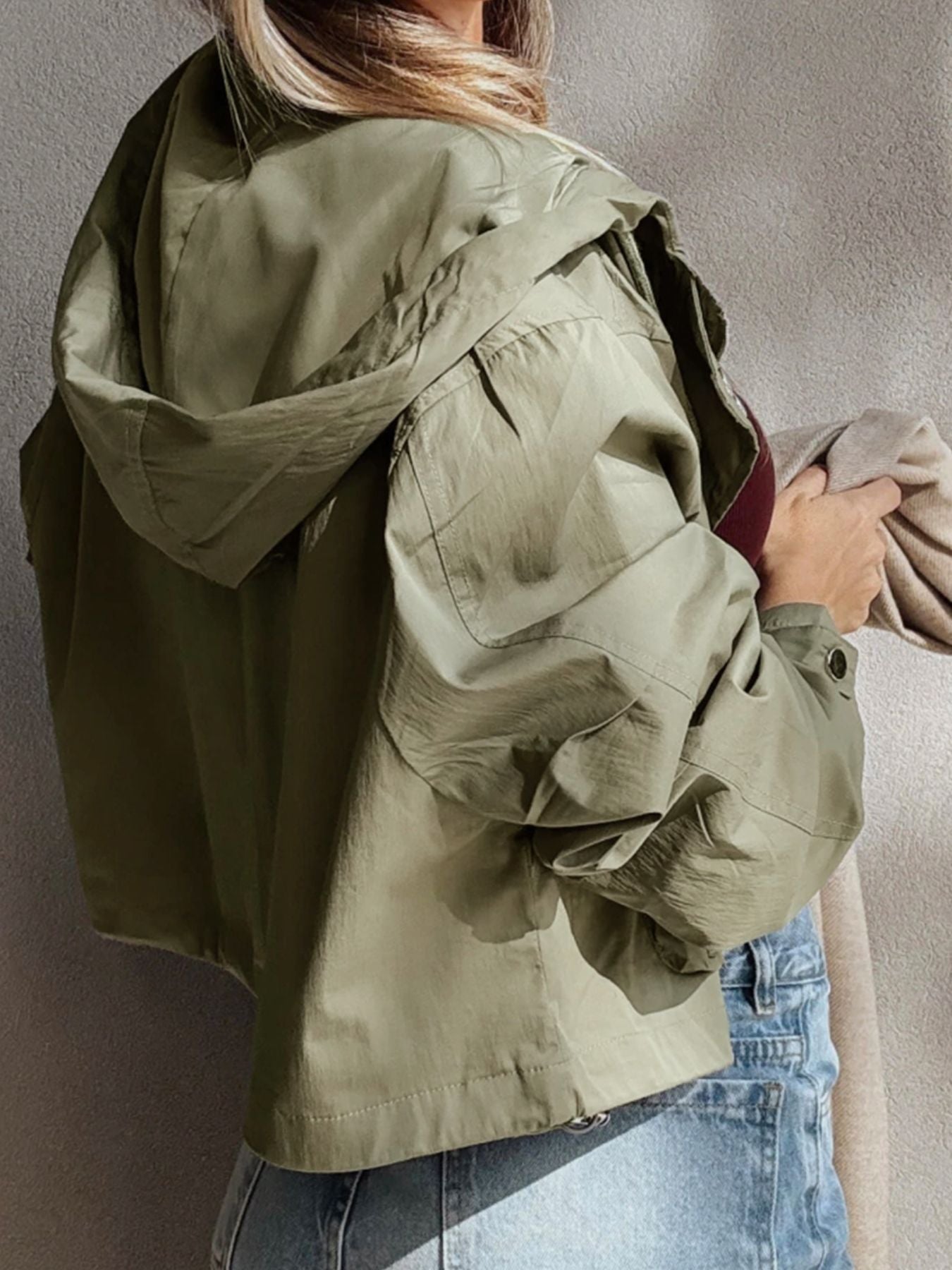 Yellow-green cropped utility jacket with hood, worn open over a tank top