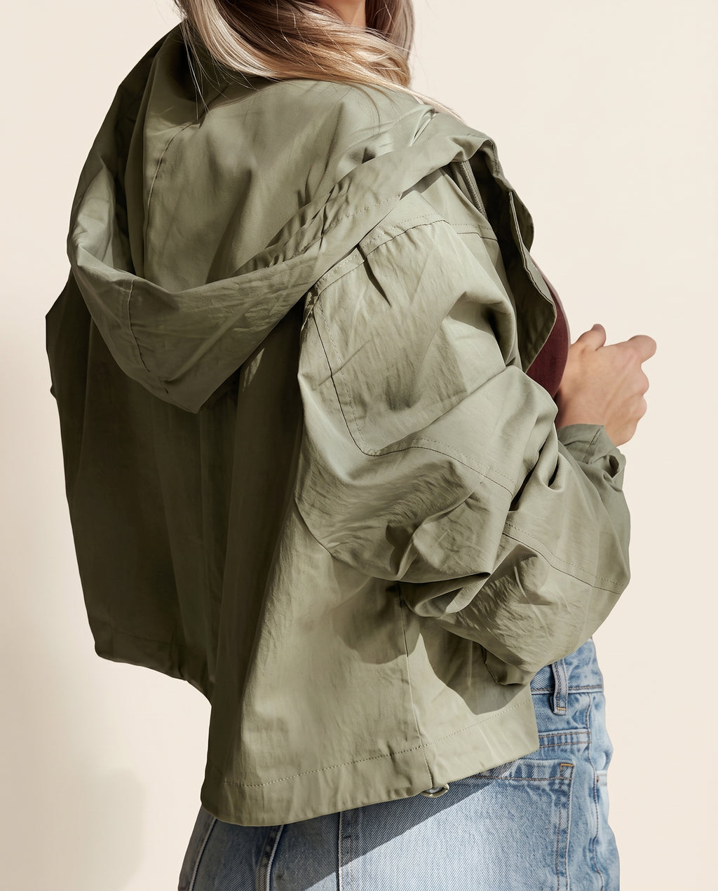Yellow-green cropped utility jacket with hood, worn open over a tank top