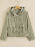 Yellow-green cropped utility jacket with hood, worn open over a tank top