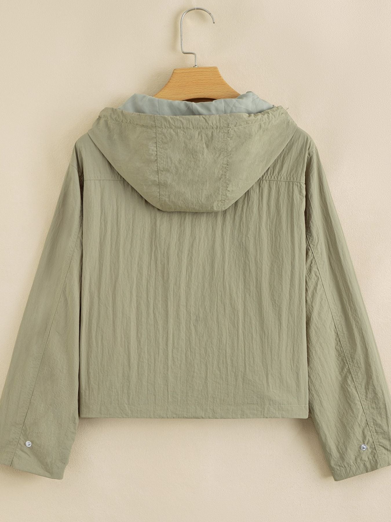 Yellow-green cropped utility jacket with hood, worn open over a tank top