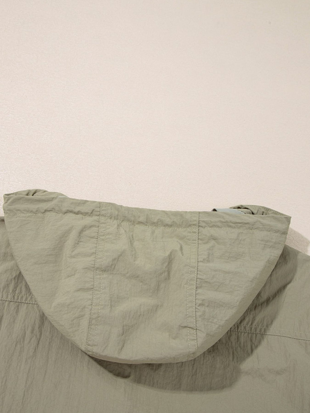 Yellow-green cropped utility jacket with hood, worn open over a tank top