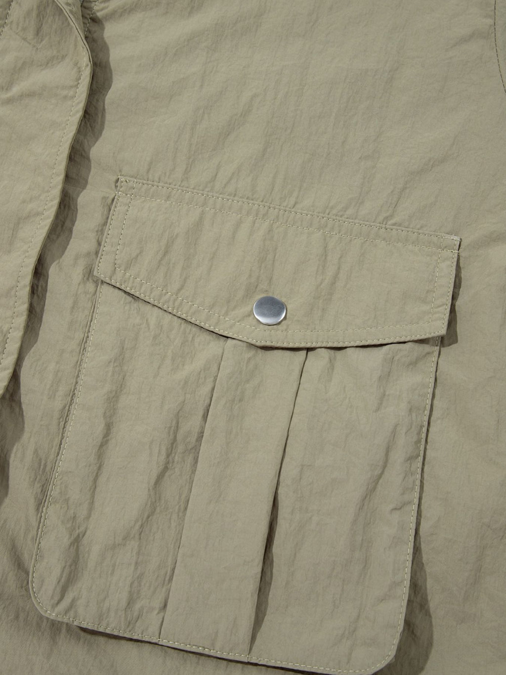 Yellow-green cropped utility jacket with hood, worn open over a tank top